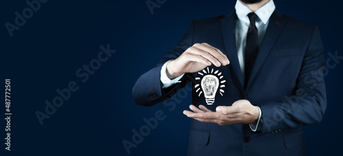 Hand of businessman holding illuminated light bulb