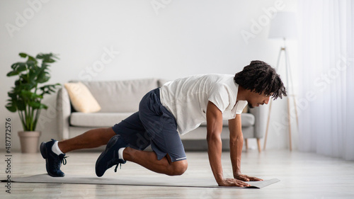 Portrait of athletic young black man practicing sport at home