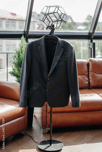 Wedding suit on a hanger in the middle of the room close-up