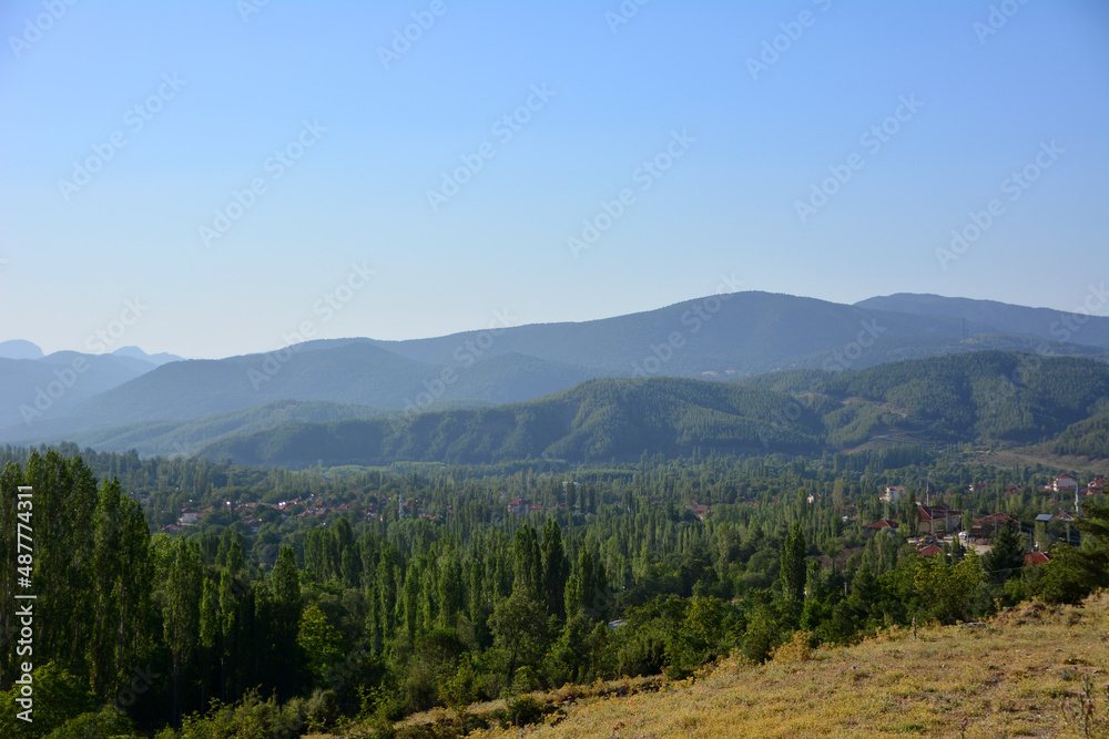 mountain range with forest line on blue sky background, Turkey