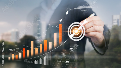 Obraz na płótnie Businessman touching virtual screen Analyzing financial and investment data, planning strategies to increase sales profits, long-term business plans