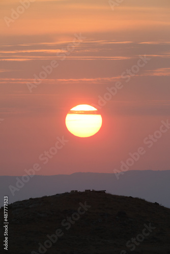 Beautiful sunrise of Judean Desert wadi, with sun rays breaking through clouds over the dry riverbed of Nahal Dragot - popular hiking trail, winding towards the Dead Sea; Israel. High quality photo photo