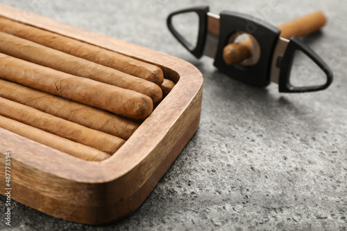 Box with cigars on grey table, closeup. Space for text