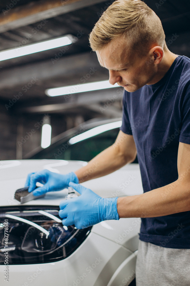 Man working car detailing and coating car Man working car detailing and coating car