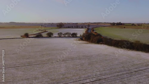 Drone flying above Yorkshire fields in the winter with snow on the ground.  photo