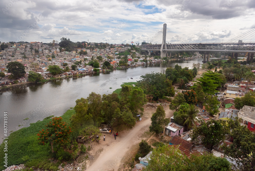 View of the poorest neighborhoods of Santo Domingo on the banks of Ozama river from teleferico cable car, slum and poverty of the capital city of Dominican Republic, Caribbean
