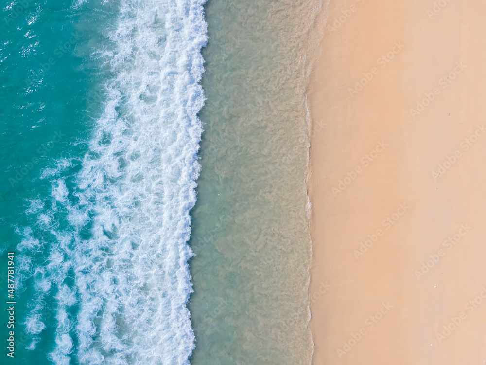 Aerial view high angle view Top-down seawater wave on sandy beach. Aerial view above beach sea in tropical beach sea. Aerial view high angle view Top-down seawater wave on sandy beach. Aerial view above beach sea in tropical beach sea.