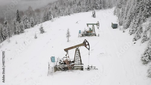 Day and night, in a severe frost and a snowstorm, a snowstorm in winter in Ukraine electric mountain pumps oil pump oil gas is a valuable raw material for energy chemical industry. drone, copter, bird