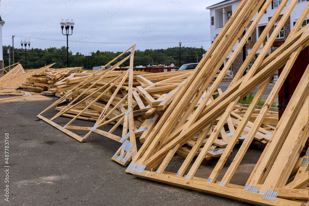 Stacked wooden timber for trusses for roof near construction site Stacked wooden timber for trusses for roof near construction site
