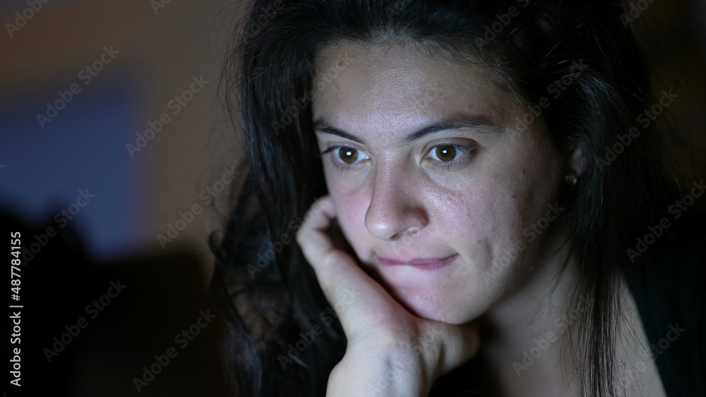 Person reading content online at night in front of laptop screen Person reading content online at night in front of laptop screen