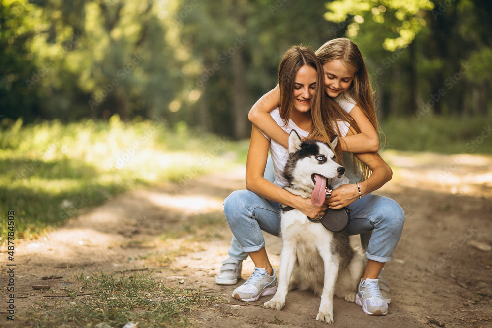 Fototapeta premium Two sisters with their dog in park