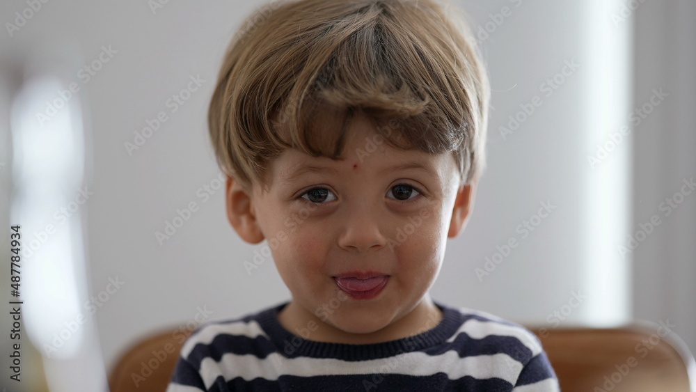 One little boy spitting misbehaving sticking tongue out One little boy spitting misbehaving sticking tongue out