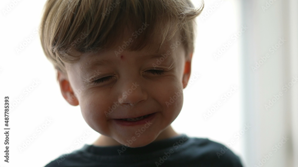 One cute goofy child eyes closed adorable kid opening eyes One cute goofy child eyes closed adorable kid opening eyes