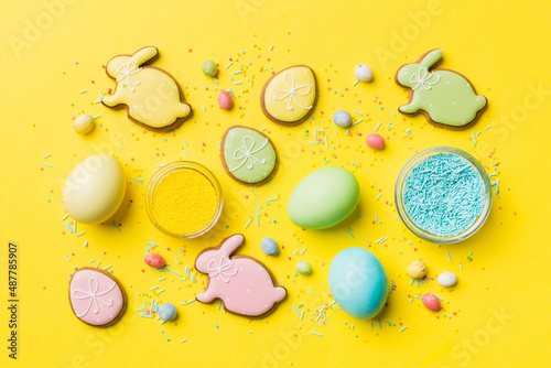 holiday preparation Multi colors Easter eggs with cookies on colored background . Pastel color Easter eggs. holiday concept with copy space