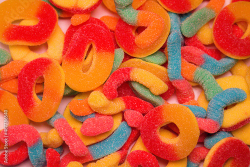 sour sweet sticky candy treat worms gum jelly closeup candies food background
