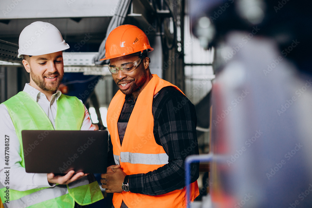 Inspector and african american worker in a factory Inspector and african american worker in a factory