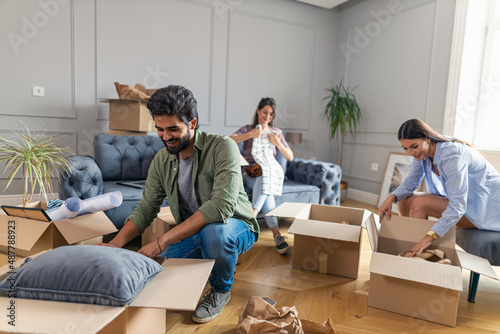 Friends becoming roommates moving in to a new apartment. photo