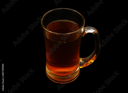 Glass cup of tea isolated on black background