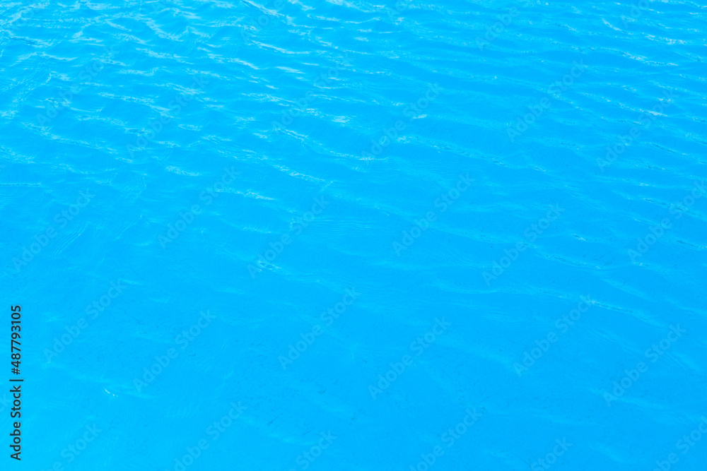 Water in the pool with blue texture background. Close up