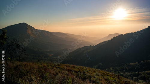 Beautiful view of sunrise or sunset in top of the mountains. Lens flare effect.