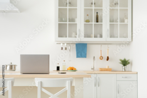 Home office in kitchen for remote work during self-isolation at COVID-19 pandemic, rent and sale flat © Prostock-studio