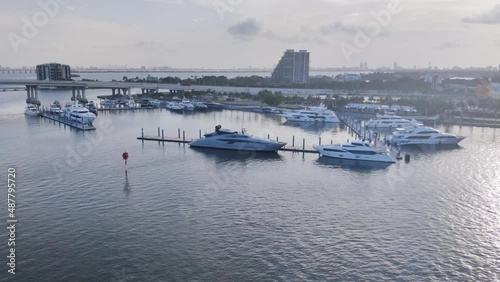 Aerial view of a Luxury yacht dockyard in Biscayne bay, Miami video background | Luxury yachts parked, Docked near a shore in Miami, drone shot video background in 4K