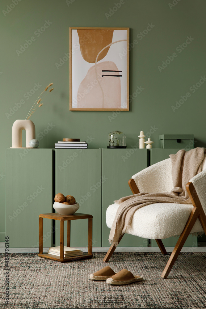 Obraz premium Modern living room interior composition with mock up poster frame, frotte armchair, wooden commode and modern home accessories. Eucalyptus wall. Template. Copy space. Real photo.