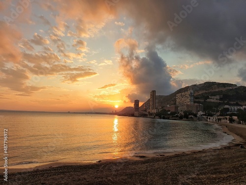 Sunset on the beach of Alicante, view of the city and the sea