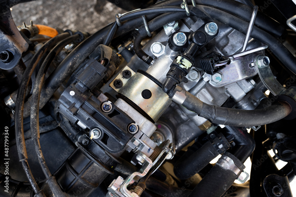 closeup detail of motorcycle engine in service center with soft-focus and over light in the background closeup detail of motorcycle engine in service center with soft-focus and over light in the background