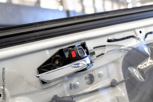 car in automobile repair service center mechanic fixing car door and body paint with soft-focus and over light in the backgroundwith soft-focus and over light in the background