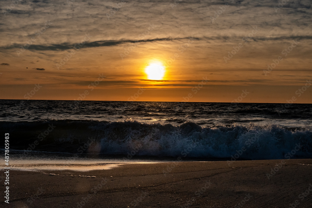 Waves breaking onto the shore at sunrise