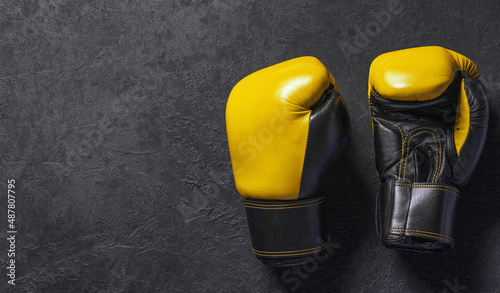 Yellow boxing gloves on a black background