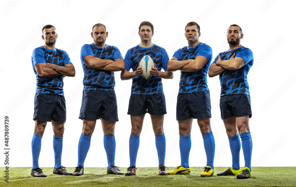 Obraz premium Group portrait of strong athletes, rugby players standing together like team isolated on white background. Sport, activity, health, hobby, occupations concept