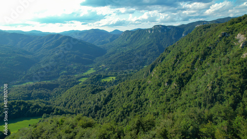 AERIAL  Scenic aerial view of the vast valley covered in lush green forests.
