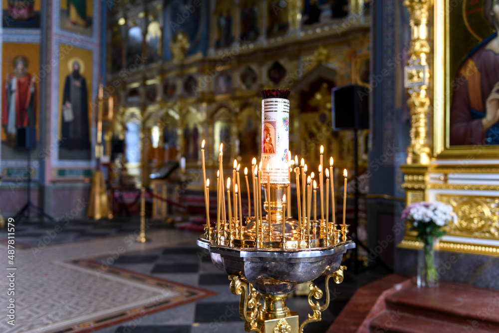 Church candles on the background of icons in Russian orthodox cathedral Church candles on the background of icons in Russian orthodox cathedral