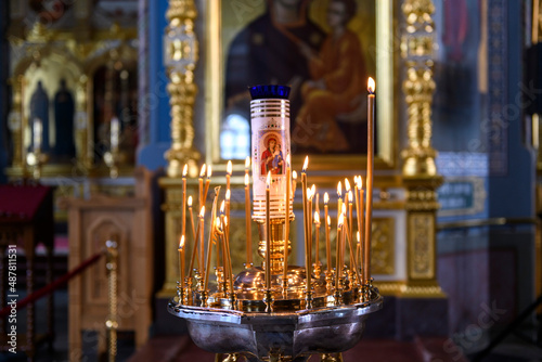 Church candles on the background of icons in Russian orthodox cathedral