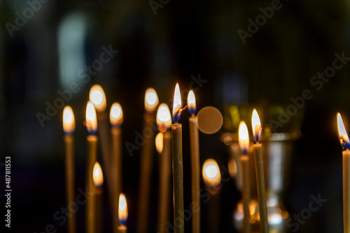 Church candles on the background of icons in Russian orthodox cathedral