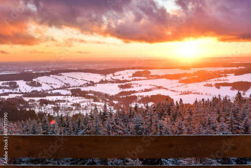 A colorful sunset in the Polish mountains of the Sudetes  the view from the top of the mountain from the Czerniec observation tower  winter evening.
