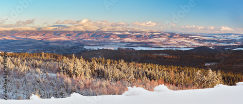 Fototapeta Naklejka Na Ścianę i Meble -  Winter landscape in the Polish mountains of the Sudetes, a view of the Snieznik Massif from the top of the mountain from the Czerniec observation tower, winter evening.