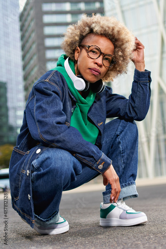 Portrait of beautiful young african woman with curly hair. Afro american female outdoors.