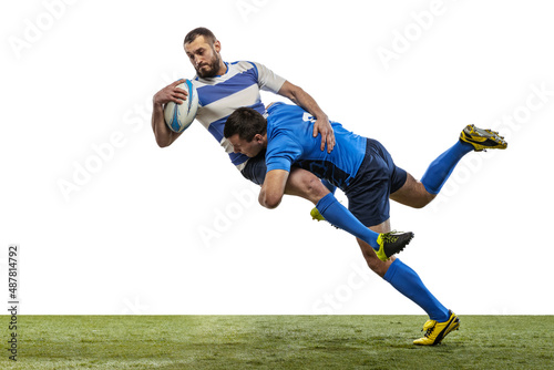 Dynamic portrait of male rugby players playing rugby football on grass field isolated on white background. Sport  activity  health  hobby  occupations concept