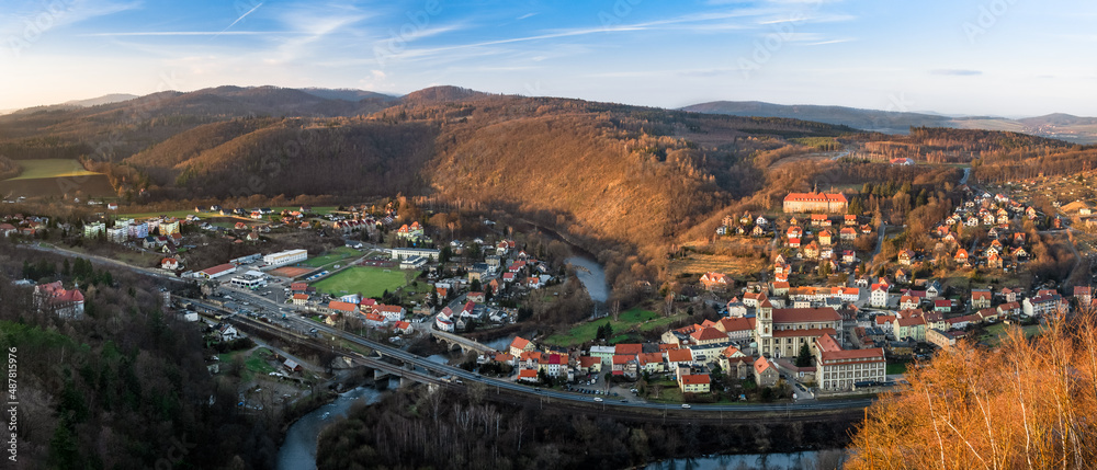 Bardo small town located in a mountain valley by the river in the Bardzkie Mountains, the view from the viewing platform at sunset.
