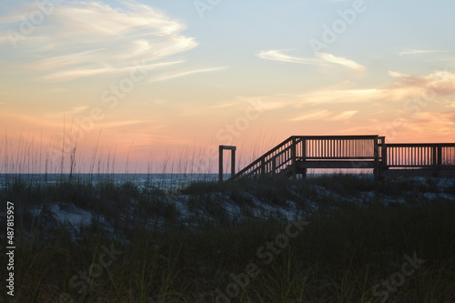 Silhouette of stairs leading down to the beach at sunset in Destin Florida