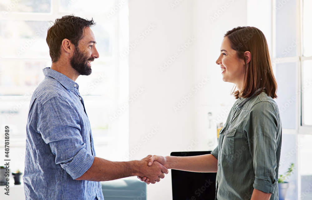 The beginning of a brand new business relationship. Shot of coworkers shaking hands in a modern office. The beginning of a brand new business relationship. Shot of coworkers shaking hands in a modern office.