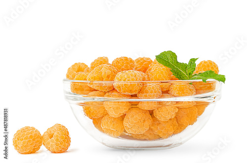 Yellow raspberries and mint leaves in a transparent bowl isolated with clipping path.