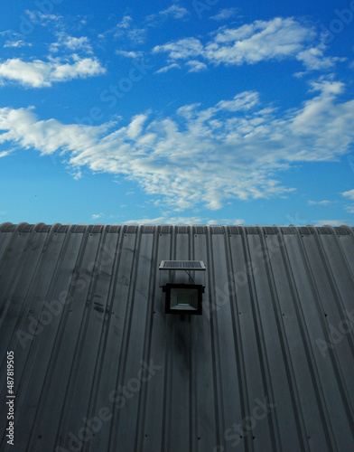 factory roof solar Blue sky and white fluffy clouds. Clean energy concept. and reduce costs