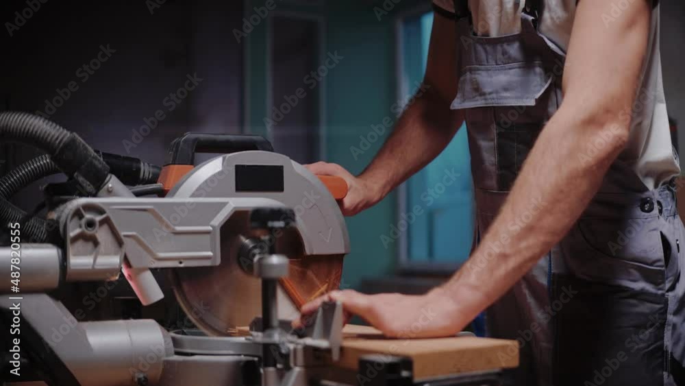 Builder cuts a wooden board on a table circular saw in construction studio. Man blows sawdust off a wooden board and checks it after cutting it. Slow motion cutting process. High quality 4k footage Builder cuts a wooden board on a table circular saw in construction studio. Man blows sawdust off a wooden board and checks it after cutting it. Slow motion cutting process. High quality 4k footage
