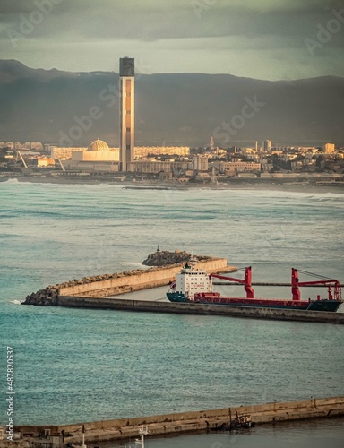 Ship at dock with the great mosque of algiers on background