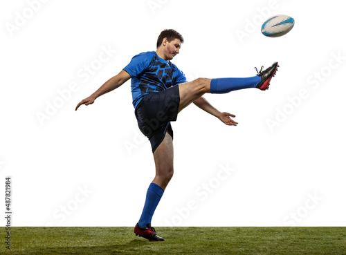 Professional rugby player wearinf blue sports uniform kicks ball isolated on white background. An incredible strain of all forces. Conversion goal photo