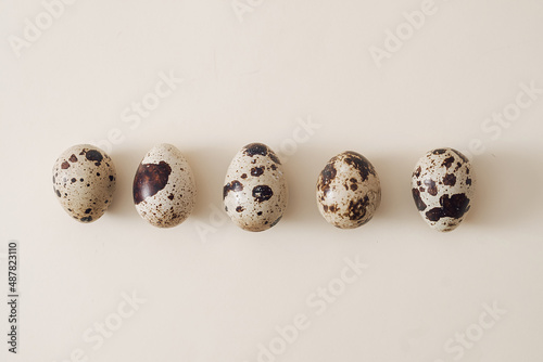 Row of small speckled quail eggs for Easter holidays